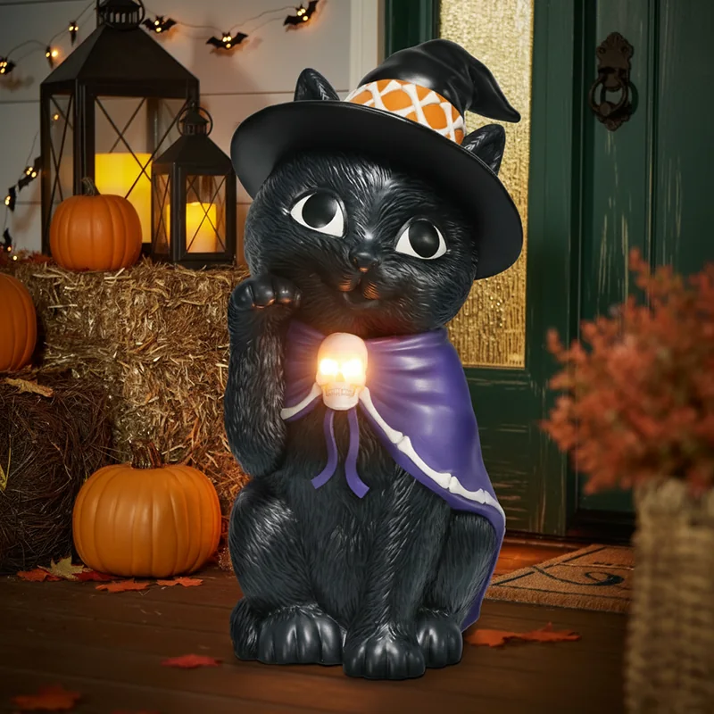 Black cat decoration wearing a pointed hat and holding an orb.